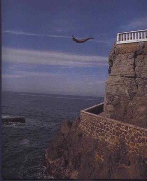 A man jumping into the welcoming water below. 